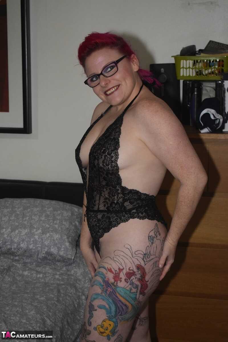 Red-haired beauty Mollie Foxxx shows off her sexy tattoos in black lingerie with glasses on.