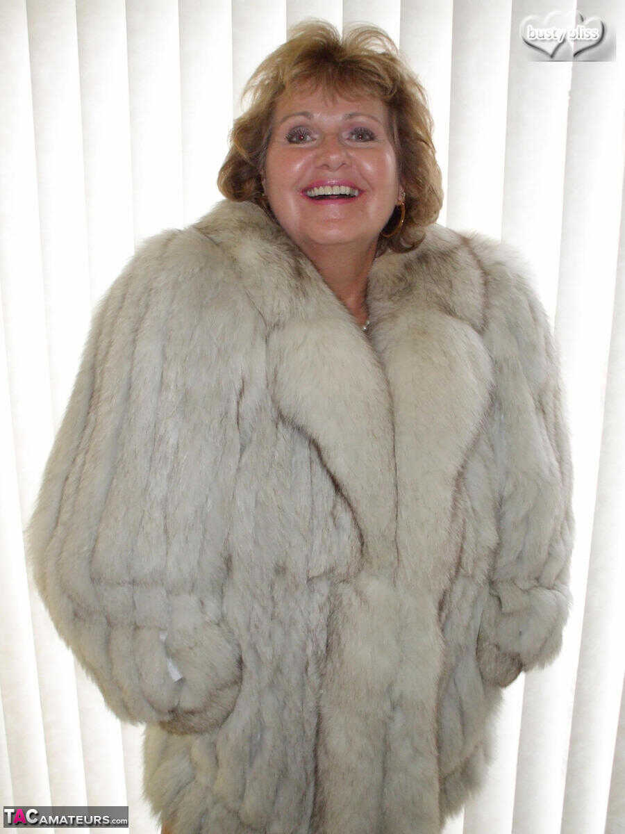 Curvy granny Busty Bliss looses her tan lined tits from a fur coat in a solo amateur session