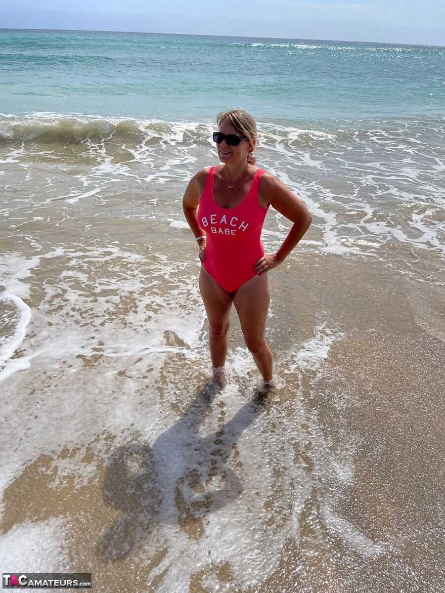 Middle-aged blonde Sweet Susi strips down on a sandy beach for some hot summer fun! - Sweet Susi