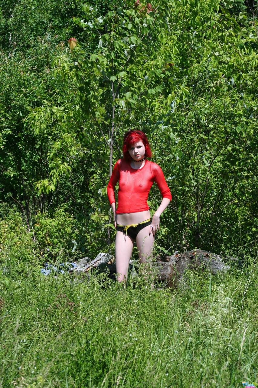 Pale redhead Teen Satine goes topless in an overgrown yard in a choker while wearing short hair and skinny jeans