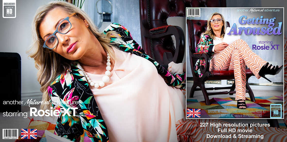 Older Blonde Rosie Xt Strokes Her Feet with a Sex Toy While Wearing Glasses on an Area Rug - Rosie Xt