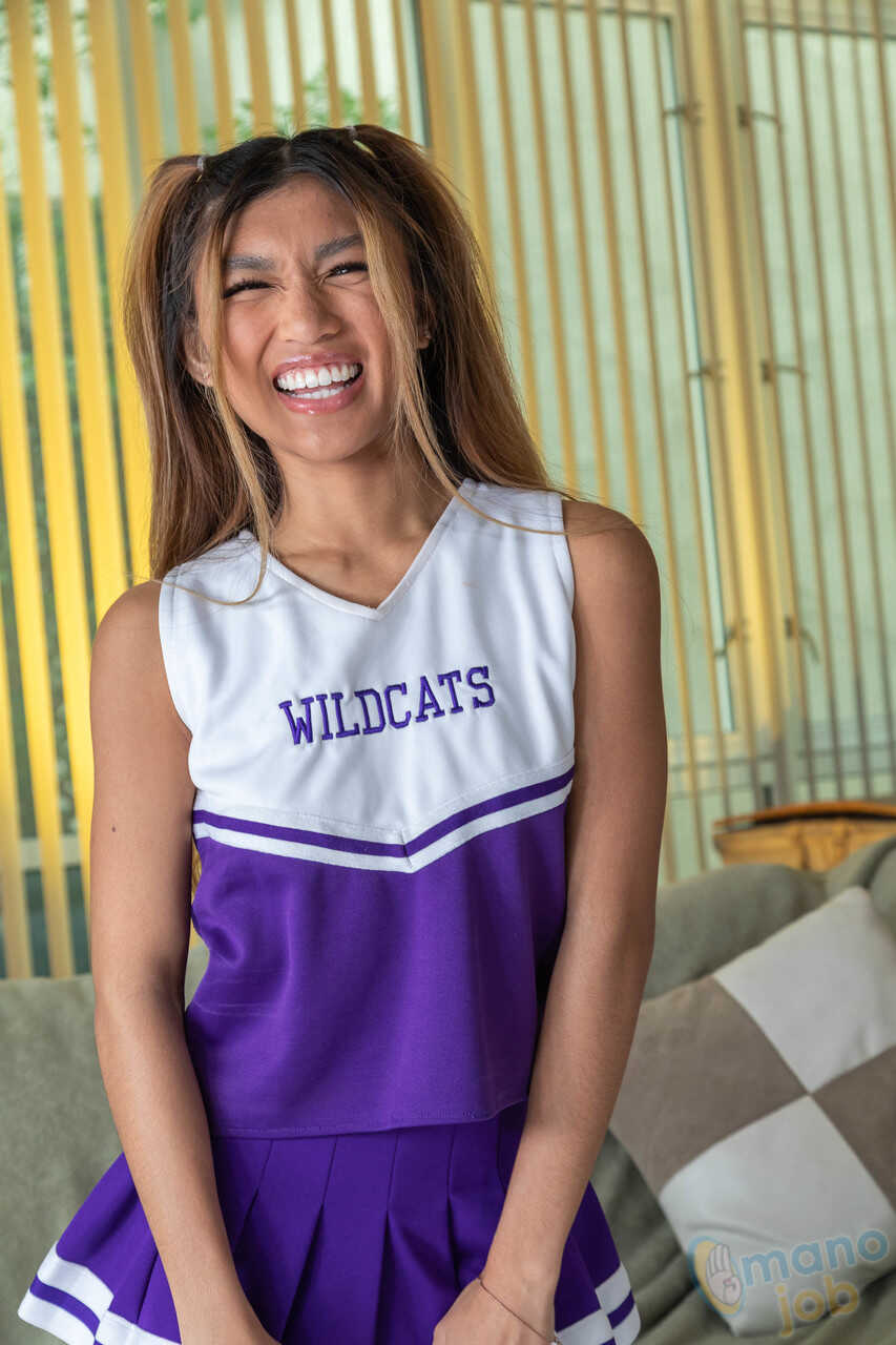 Busty Asian Cheerleader Clara Trinity Pops a Cock with Her Feet after Getting Down and Dirty on the Ground - Clara Trinity