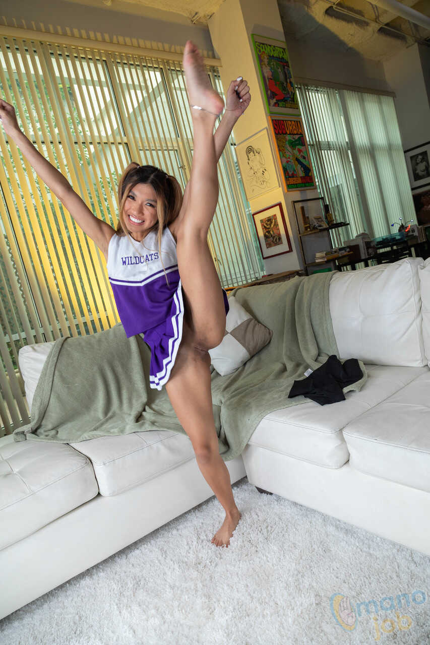 Busty Asian Cheerleader Clara Trinity Pops a Cock with Her Feet after Getting Down and Dirty on the Ground - Clara Trinity