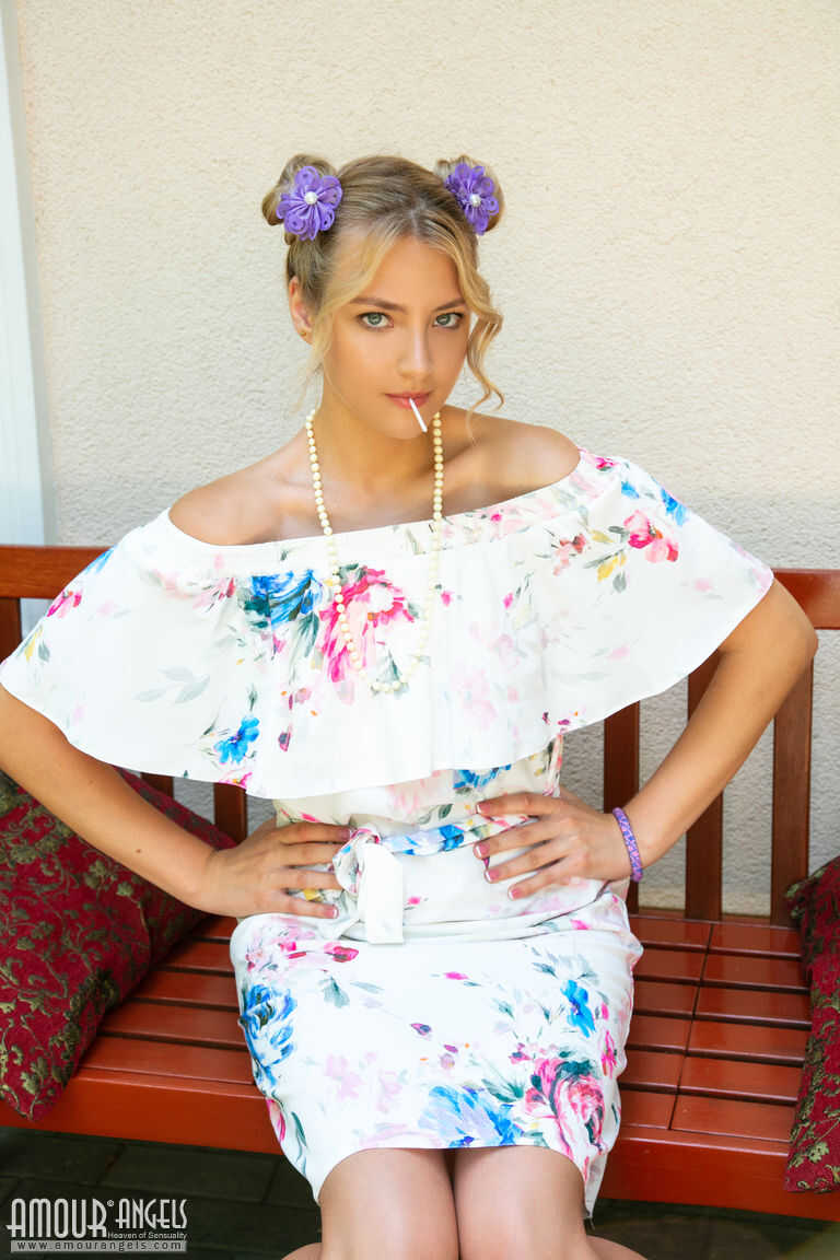 Beautiful blonde teen Sallie sucks on candy while going nude on a patio bench   Sweet Sucking Sallie's Patio Pleasure...
