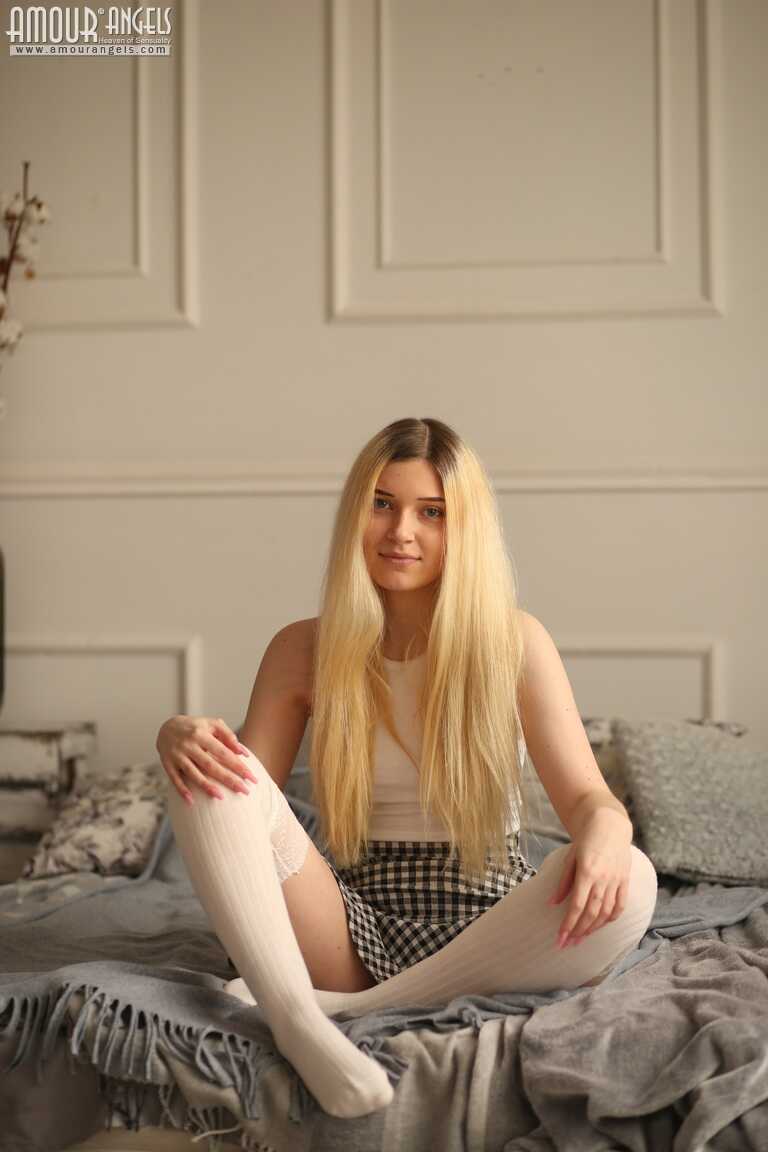Young blonde Suna slowly removes her clothing on top of her bed, exposing her perfect teen body and tight ass bent over fo...