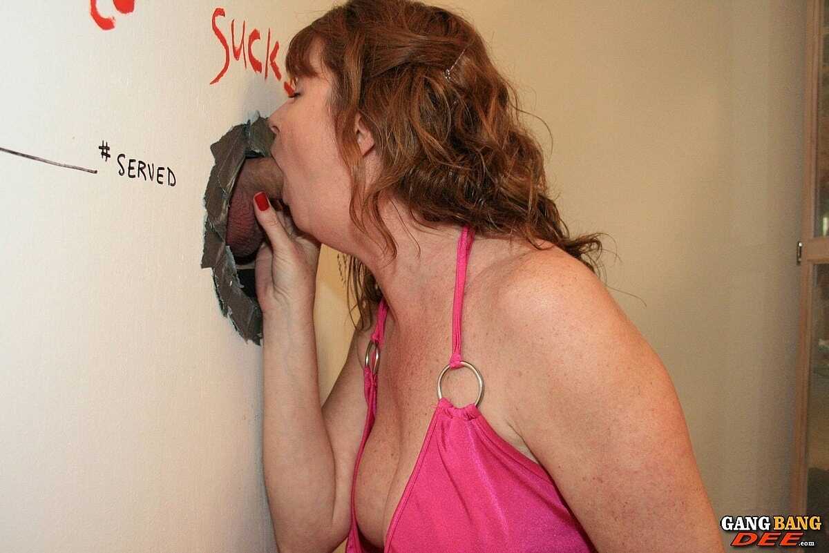 Redhead Dee Delmar's Mature Natural Tits Get Sucked At The Gloryhole