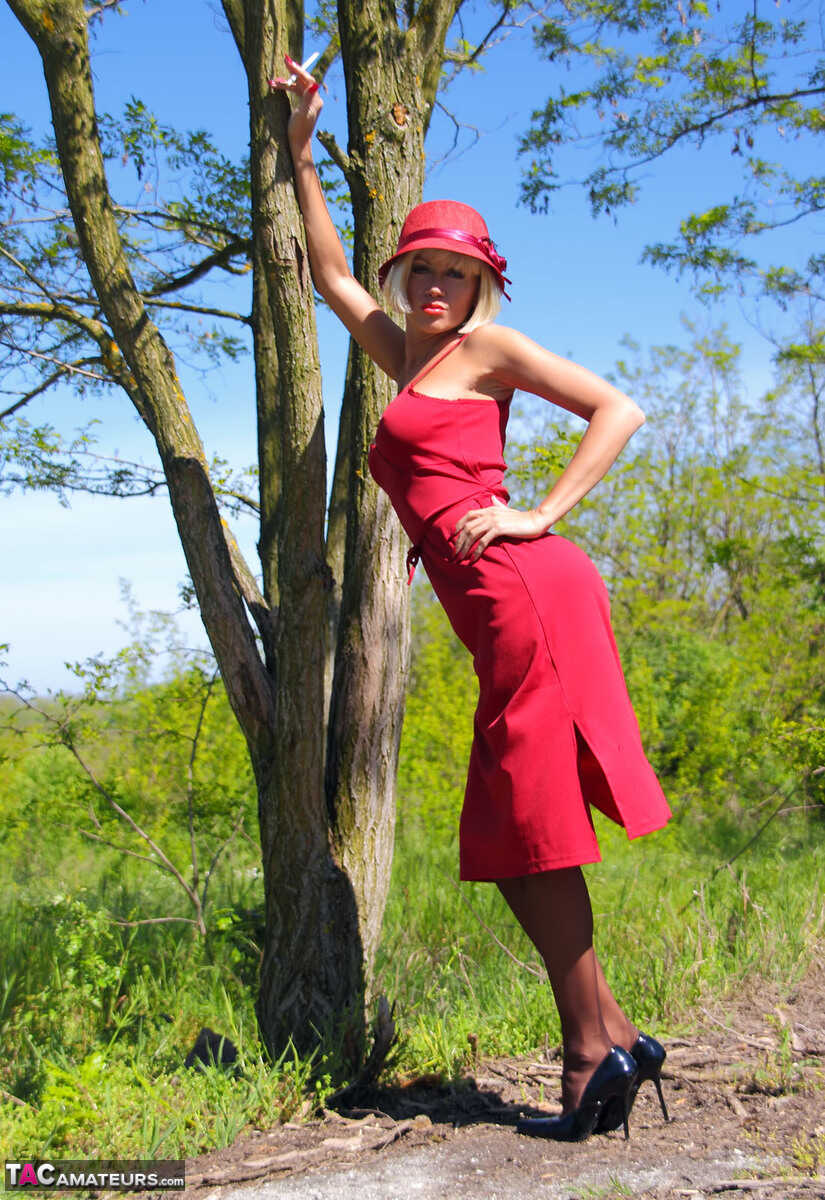 Blonde MILF Eva Diangelo Shows off her Naughty Side against a Tree in Nylons and High Heels Stockings - Eva Diangelo