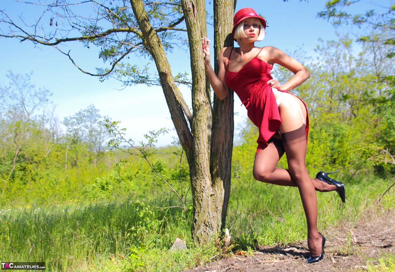 Blonde MILF Eva Diangelo Shows off her Naughty Side against a Tree in Nylons and High Heels Stockings - Eva Diangelo