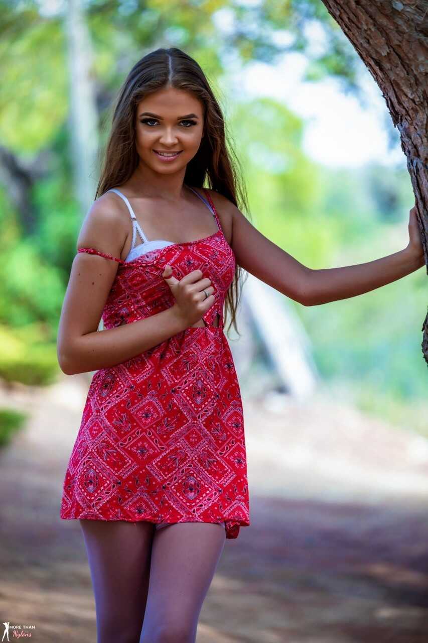 Skinny beauty Tara King goes wild in the woods with a sexy top-less striptease against the tree! - Tara King