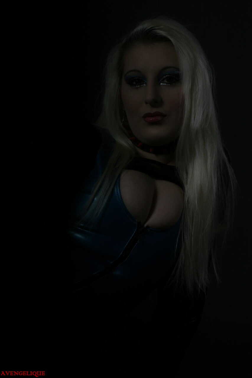 Blonde in Latex Boots, Striking a Seductive Pose for the Camera - Avengelique