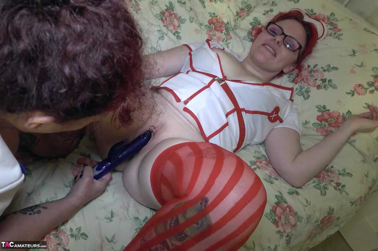 British nurse Mollie Foxxx's thick and chubby pussy gets lesbian-style masturbated by her curvy glasses-wearing friend with a pierced pussy!