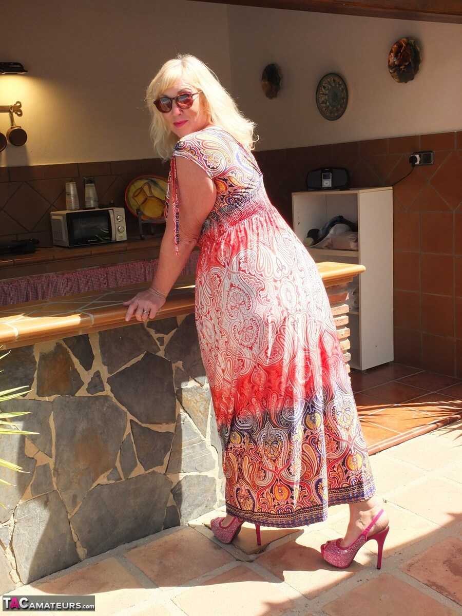 Fat mature blonde Melody shows her big ass in tight panties during upskirt action in shades. - Melody