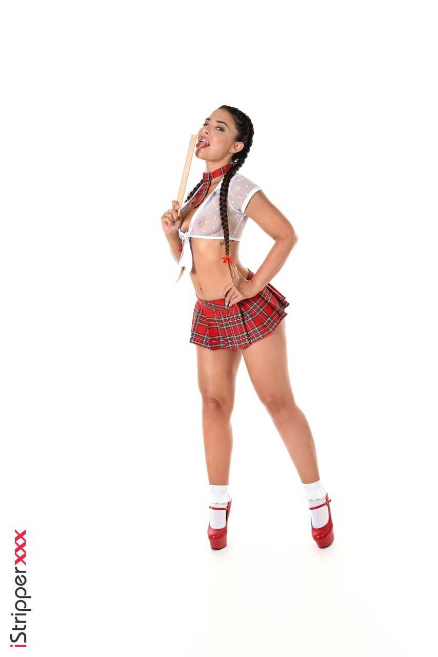 Brunette schoolgirl Nuria Millan toys her pussy in frilly white socks while wearing a sexy school uniform and lacy panties...