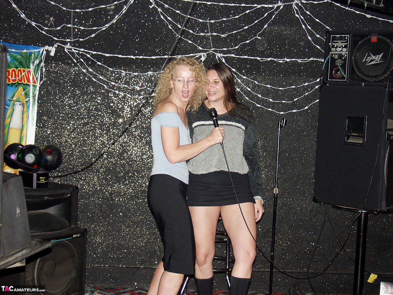 Ginger Klixen engages in public fisting with a nerdy MILF inside a hairy dive nightclub! - 