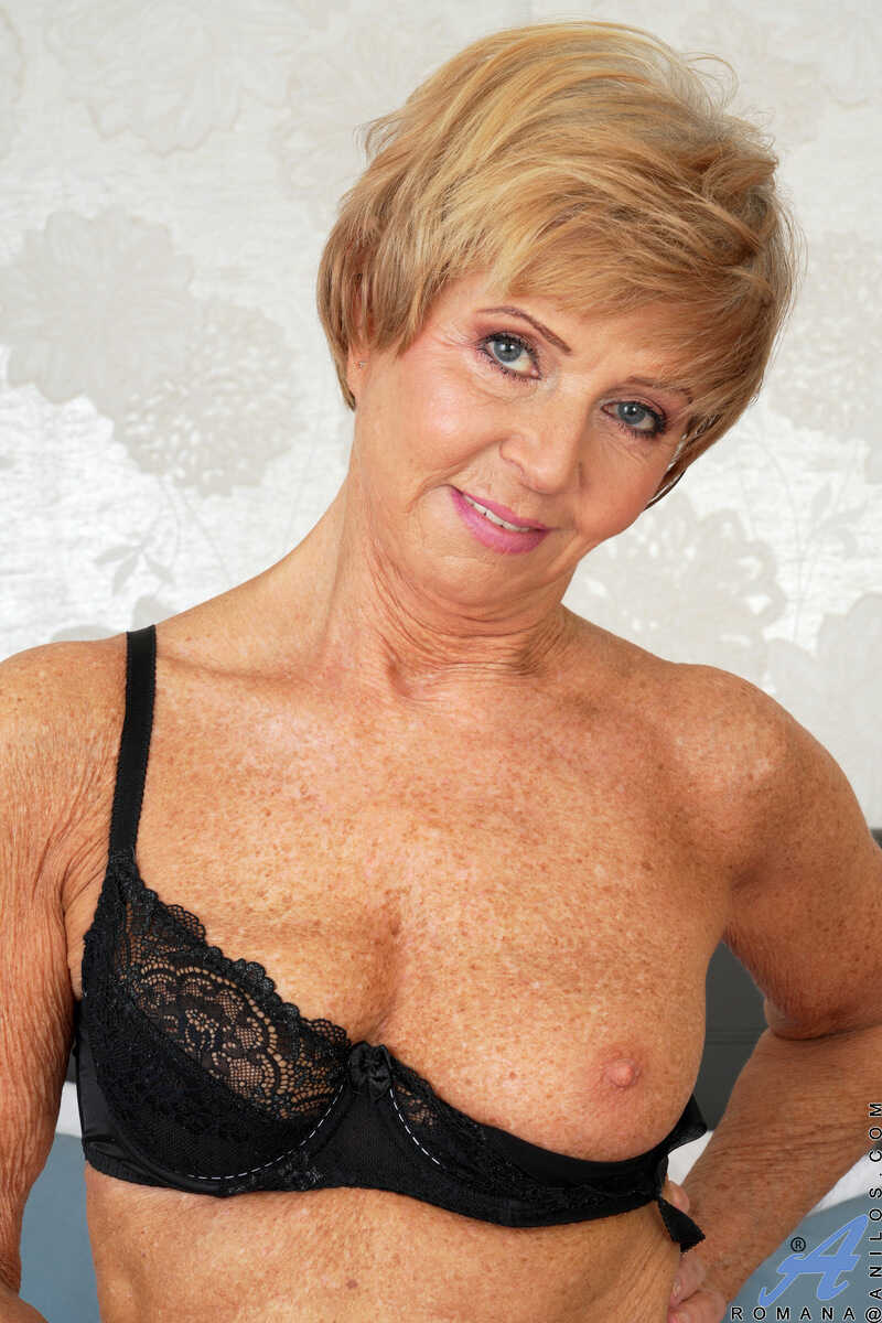 Redheaded granny Romana's shaved pussy spreads wide on a bed of stockings in 'Granny Overload' - Romana