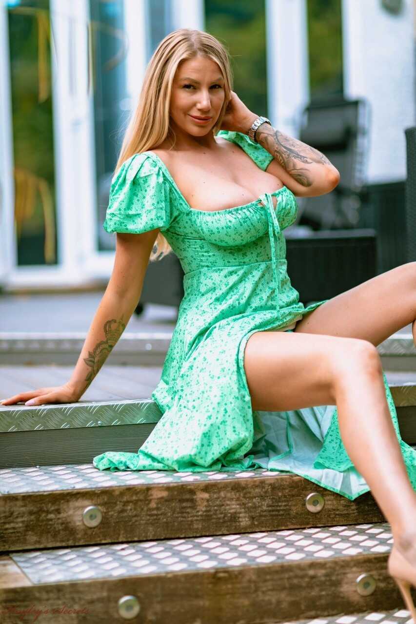 Towering UK blonde Danielle Maye unleashes her massive titties on a patio in high heels while wearing a tiny bikini and sh...