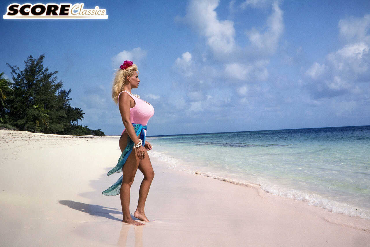 Blonde bombshell Lisa Lipps shows off her massive titties on a tropical beach in a micro bikini! - Lisa Lipps
