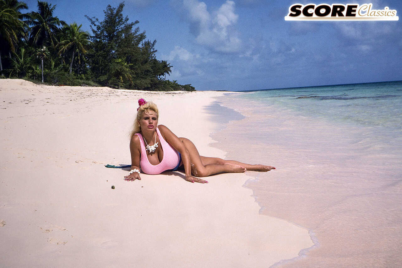 Blonde bombshell Lisa Lipps shows off her massive titties on a tropical beach in a micro bikini! - Lisa Lipps
