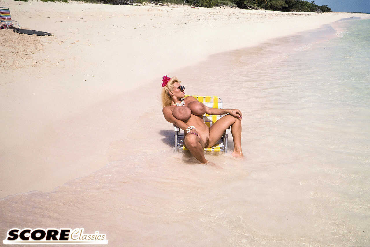 Blonde bombshell Lisa Lipps shows off her massive titties on a tropical beach in a micro bikini! - Lisa Lipps