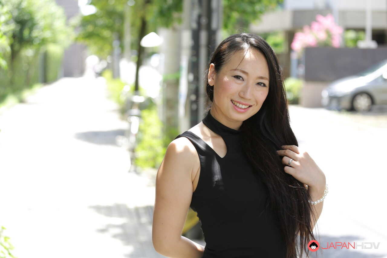 Public flashing with hot Japanese beauty Aya Shiina in a short black dress on a city street - Aya Shiina