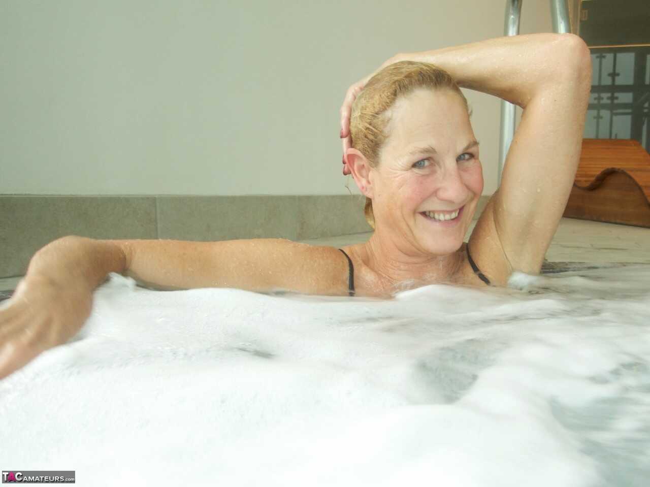 Sultry Molly in her Hot Tub, Sucking on a Popsicle While Wearing Her Micro Bikini - Molly Milf