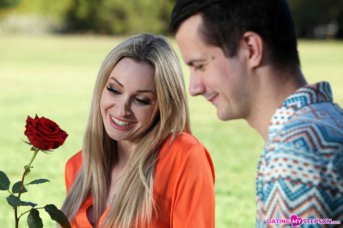 Micky Muffin receives a red rose as her lover Sam Bourne approaches from behind and enters her in passionate fashion.