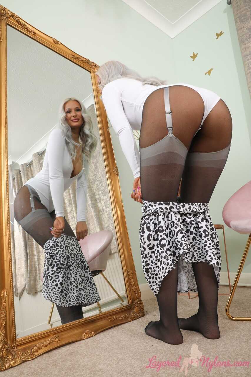 Platinum blonde Paige F teases you with her nylon-clad legs in high heels and skirt - Paige F