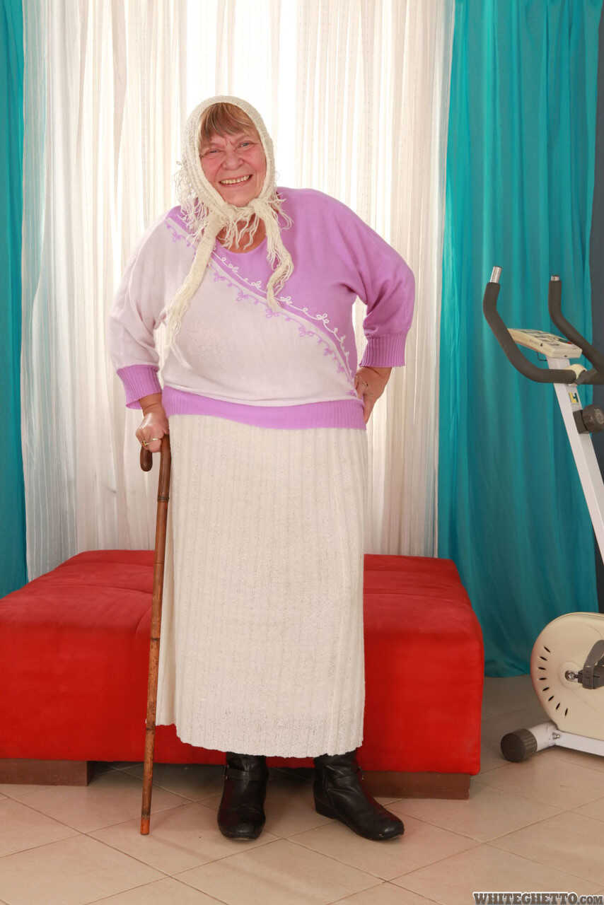 Wrinkled Granny Sara G Slips out of Her Skirt and Boots to Show Off Her Huge Tits in a Bra - Sara G