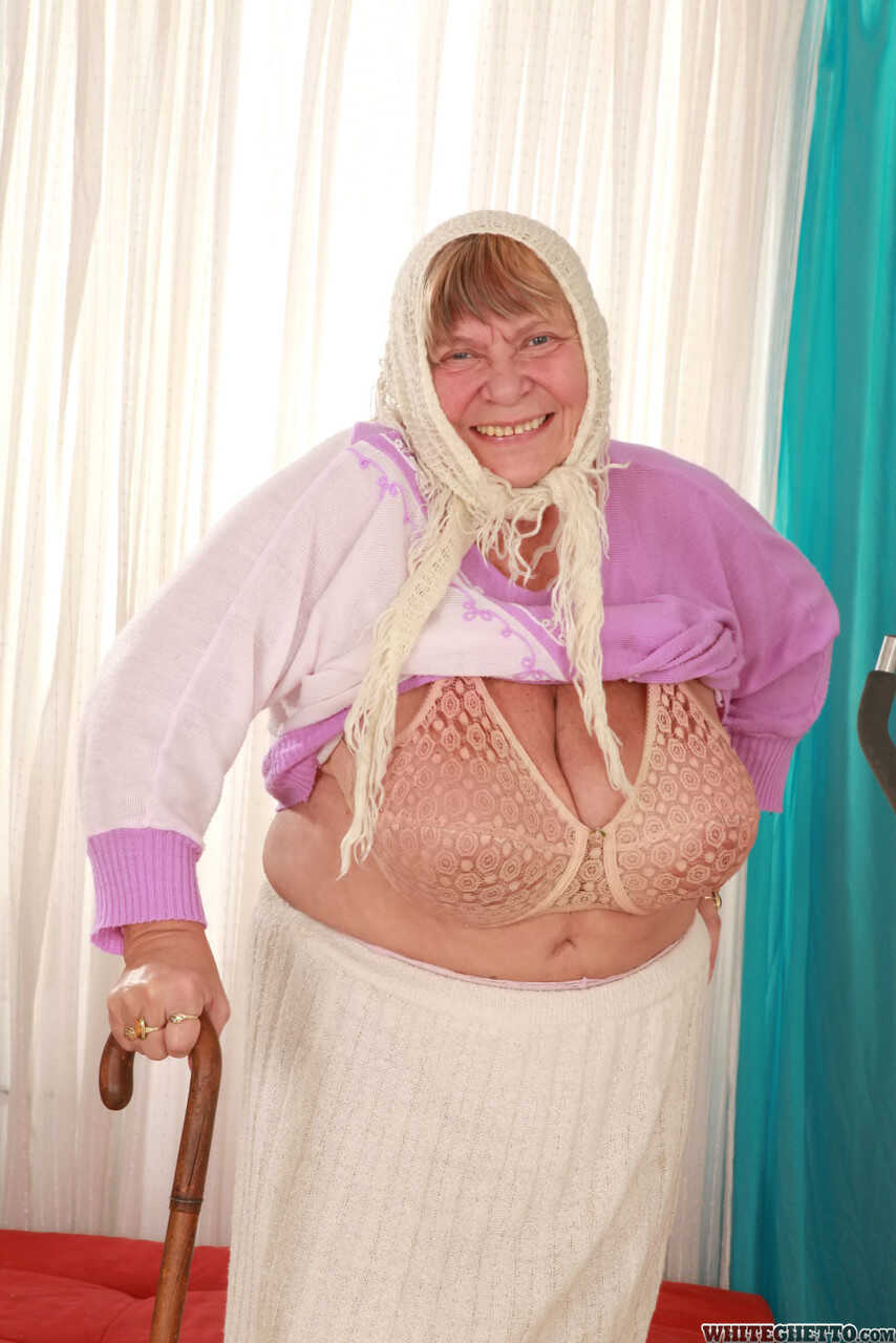 Wrinkled Granny Sara G Slips out of Her Skirt and Boots to Show Off Her Huge Tits in a Bra - Sara G