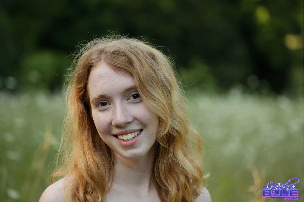 Young, Natural Redhead Nicki Blue Explores the Wild as She Poses Nude in a Lush Field of Greenery