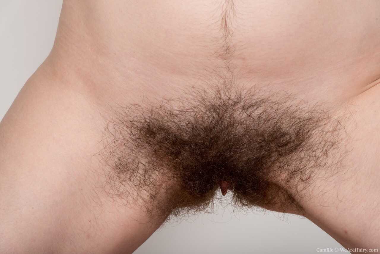 Hairy Camille stretches out her beaver after getting undressed, showing off her sexy ass and pussy. - Camille