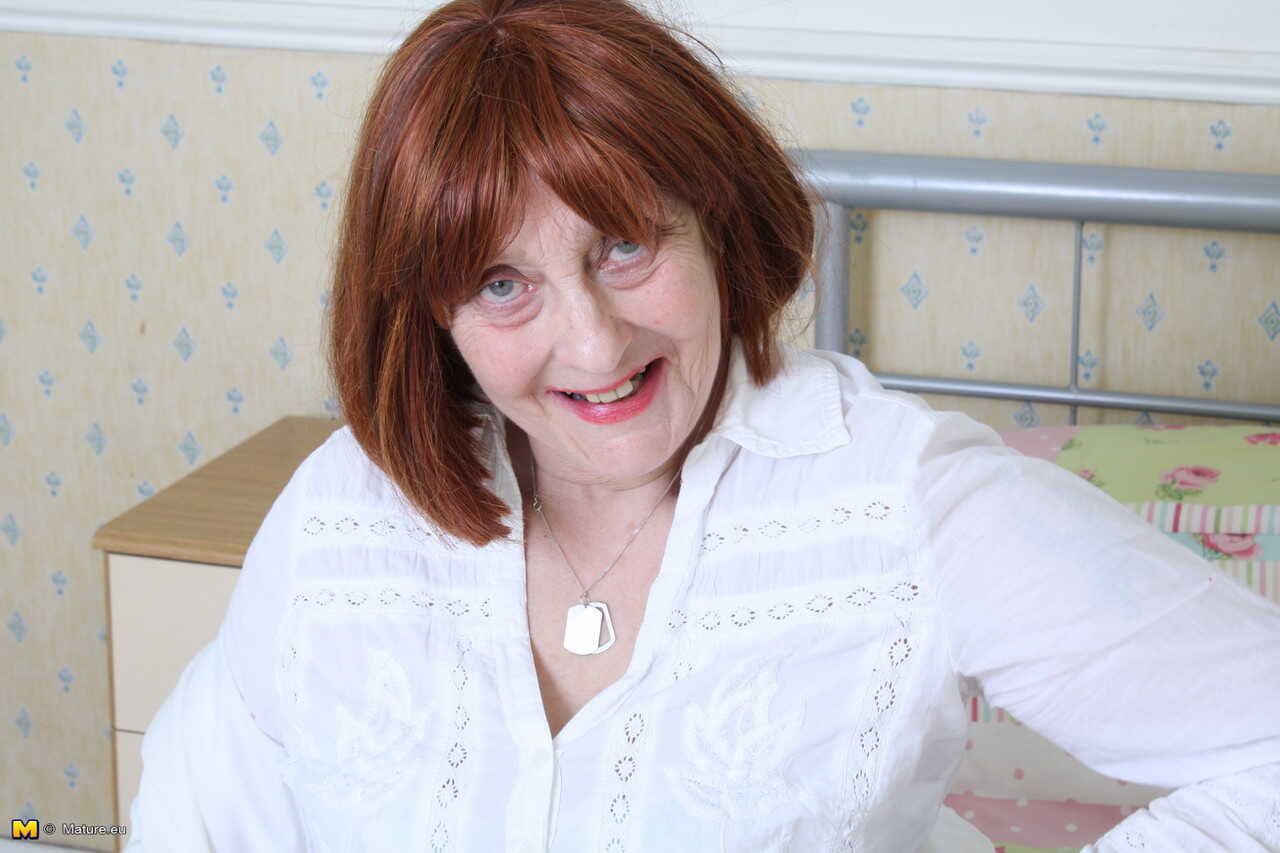 Redhead older granny in black stockings teases with her hot ass on display - 