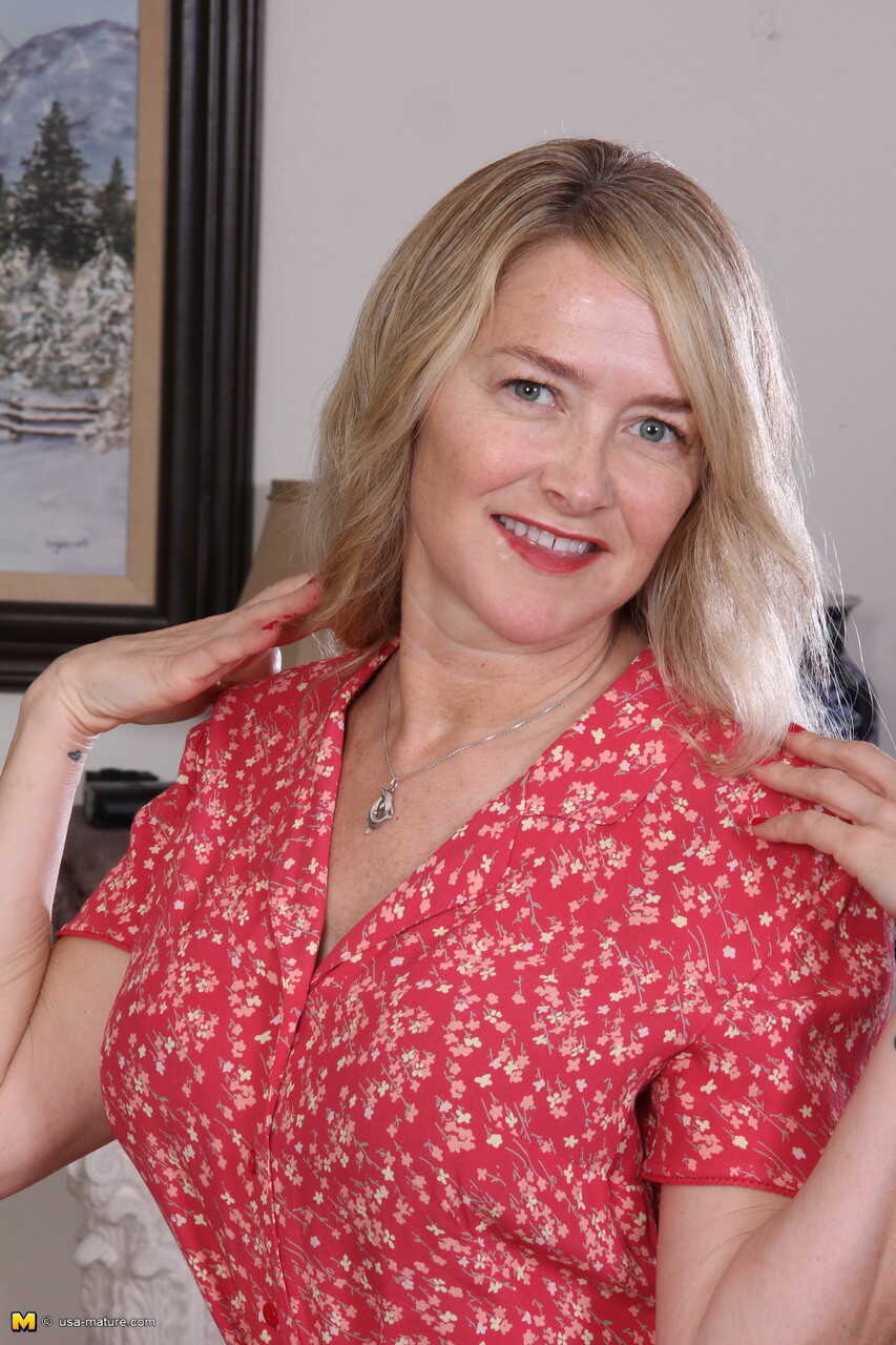 Blonde American housewife Eva Griffin flashes open dress before proceeding to undress, exposing her sexy mature body in pa...
