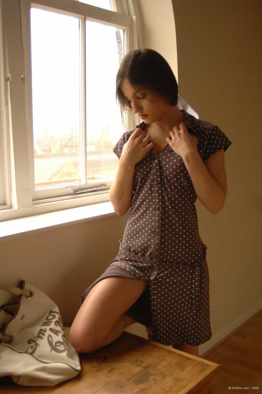 Sexy Mature Woman Poses Seductively In Front Of A Window While Slipping Off Her Dress And Underthings - 
