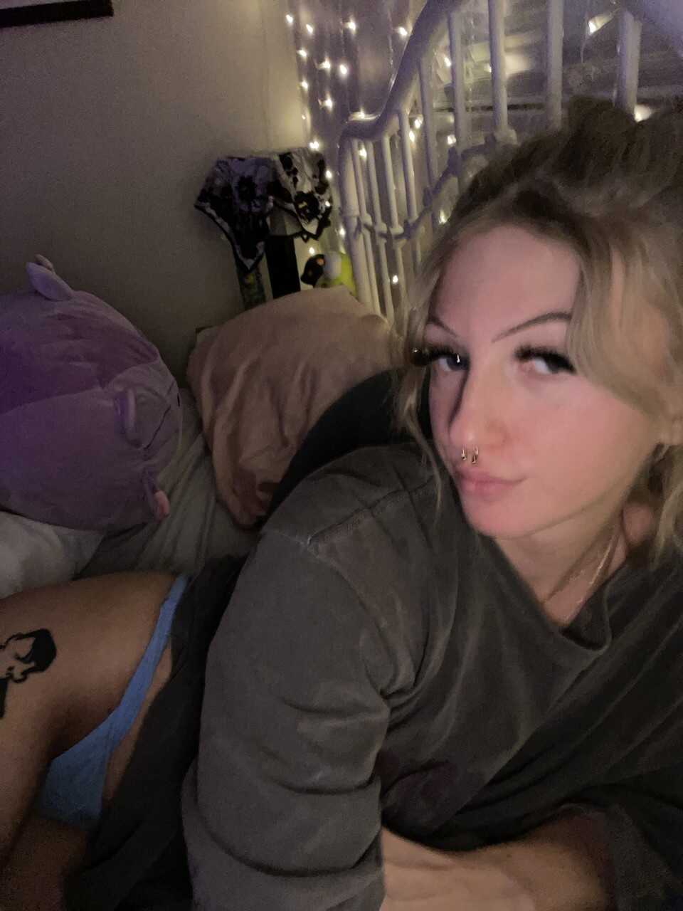 Skinny OnlyFans model Blondie Alexis poses provocatively in a solo mirror selfie, teasing her nerdy glasses-wearing follow...