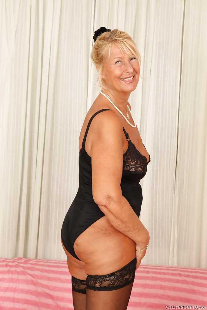 Short-haired blonde granny Regi is demonstrating her gorgeous boobs for her young lover's pleasure. - Regi