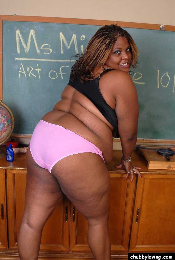 Mature ebony teacher Minxx is undressing in the classroom