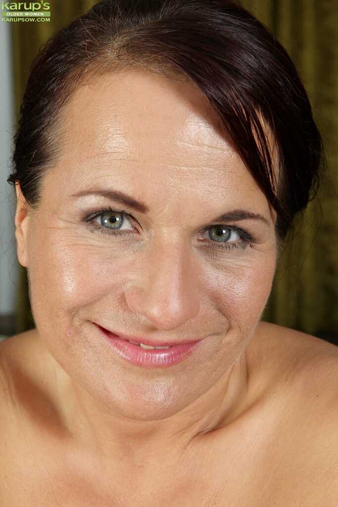 Chubby older woman Katherine Ross spreads her shaved pink kitty wide while masturbating for the camera, showing off her bi...