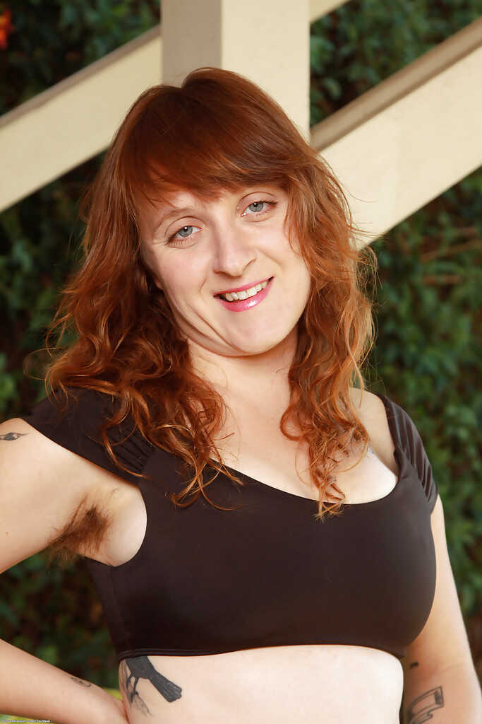 Mature redhead model Velma flashes her hairy armpits and vagina in the great outdoors! - Velma