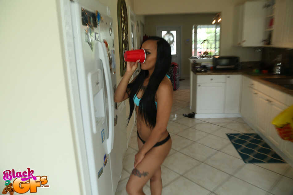 Petite ebony babe Payton Banks shakes her ass in thong panties for the camera in the kitchen - Payton Banks
