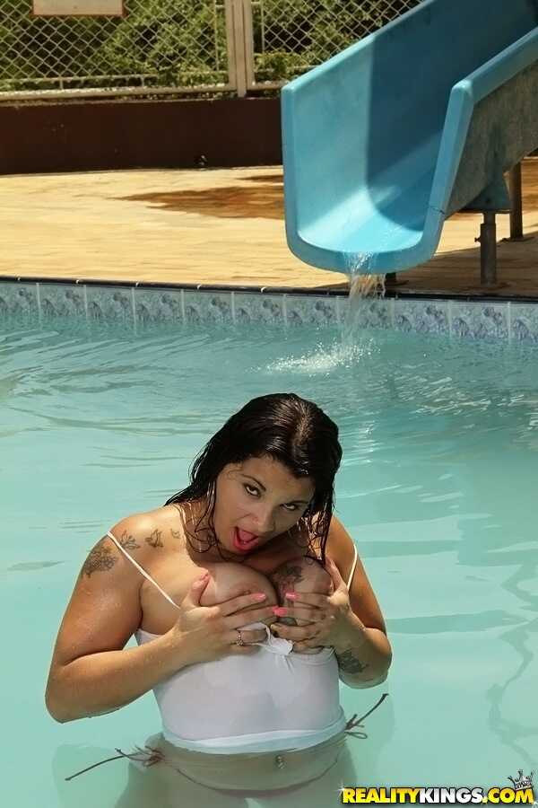 Hot Cristine Castellari's big boobs sway in the swimming pool as she shows off her Latina ass in shorts