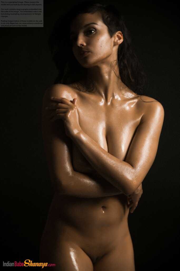 Naked Shanaya exposes a single breast while modeling in the dark 