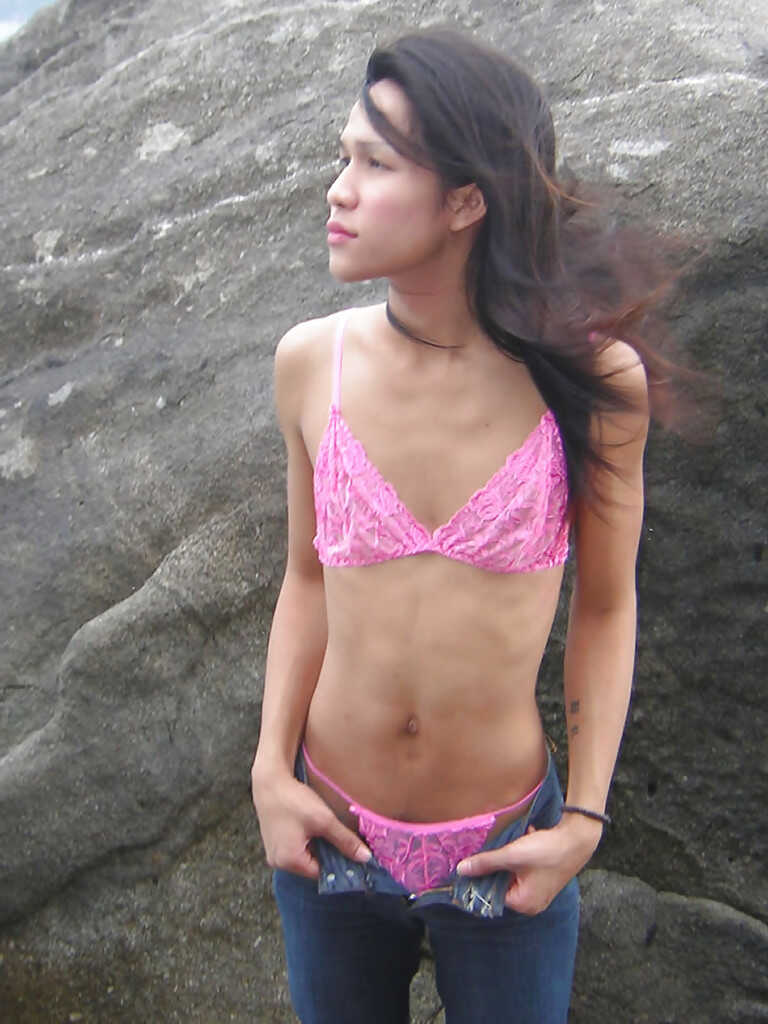 Skinny Asian shemale Ho, outdoors and in the open, shows off her long and slender legs while masturbating with a huge cock...