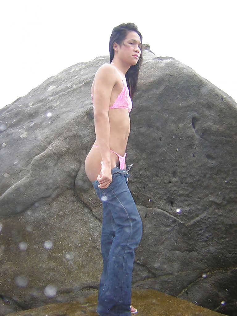Skinny Asian shemale Ho, outdoors and in the open, shows off her long and slender legs while masturbating with a huge cock...