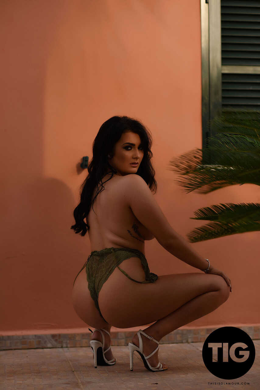 Curvaceous British model Ashleigh Gee strips down to her sheer bodysuit and poses outside, teasing with her big natural ti...