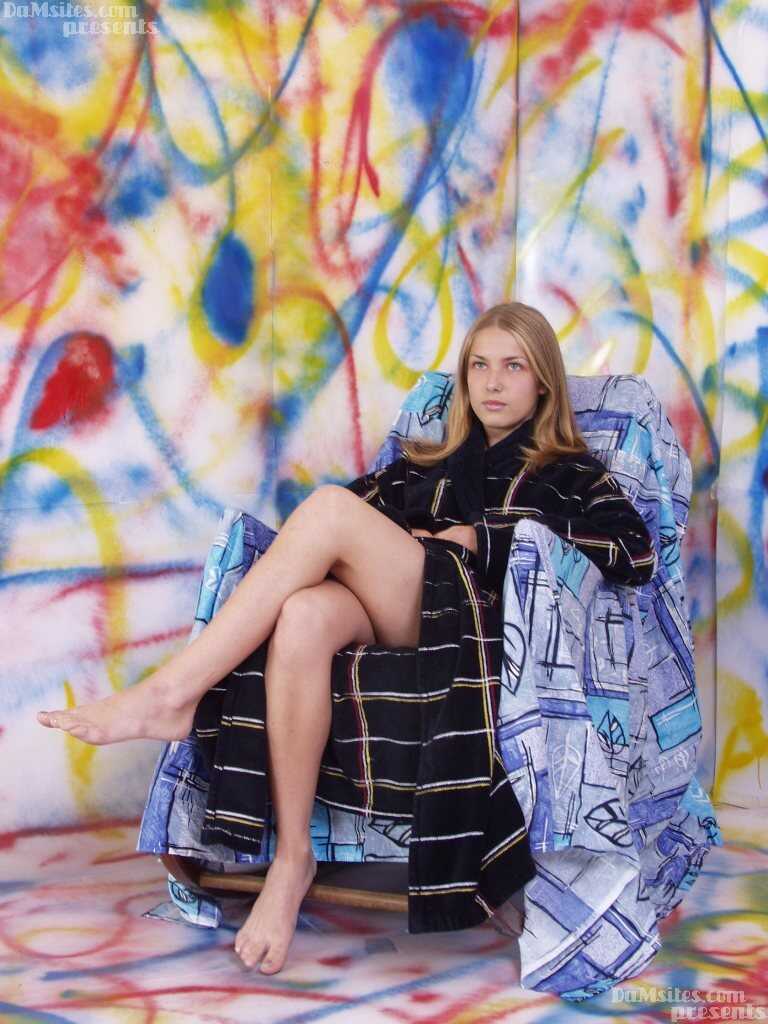 Pretty European teen Alina's small breasts get exposed while she rests on a chair - Alina