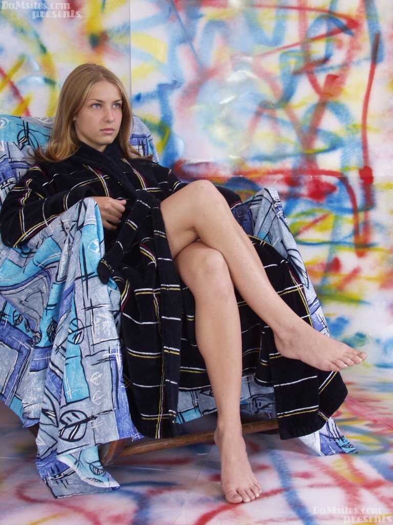 Pretty European teen Alina's small breasts get exposed while she rests on a chair - Alina