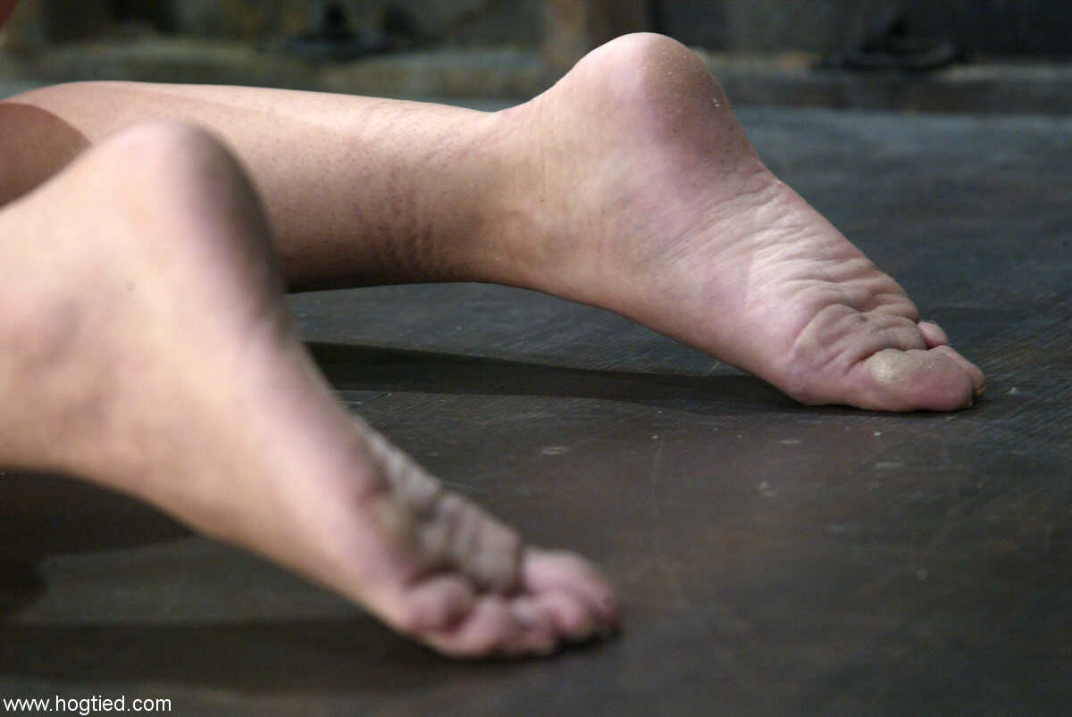 Ball-gagged Sarah Blake gets her ass caned with a huge dildo while her redhead feet get punished - Sarah Blake