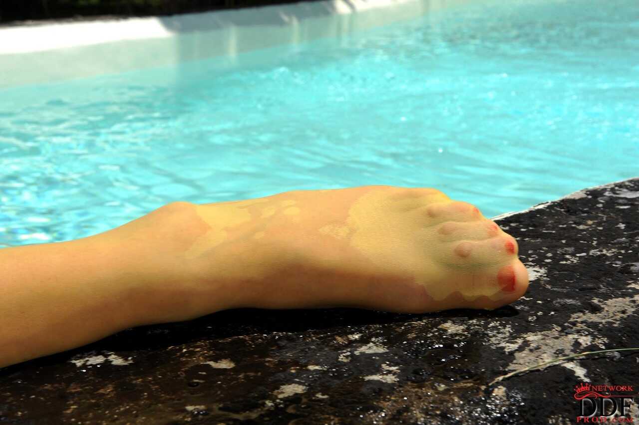 Czech redhead Kety Pearl rubs her twat poolside with an oily body and reveals a wet panties and open legs - Kety Pearl