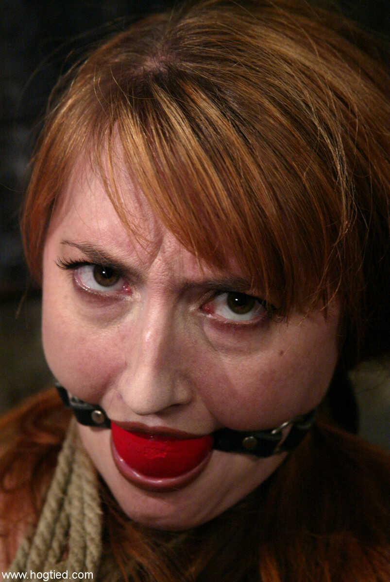 Redheaded babe Kendra James gets tied up, gagged and ravaged by two rough men in the basement - Kendra James